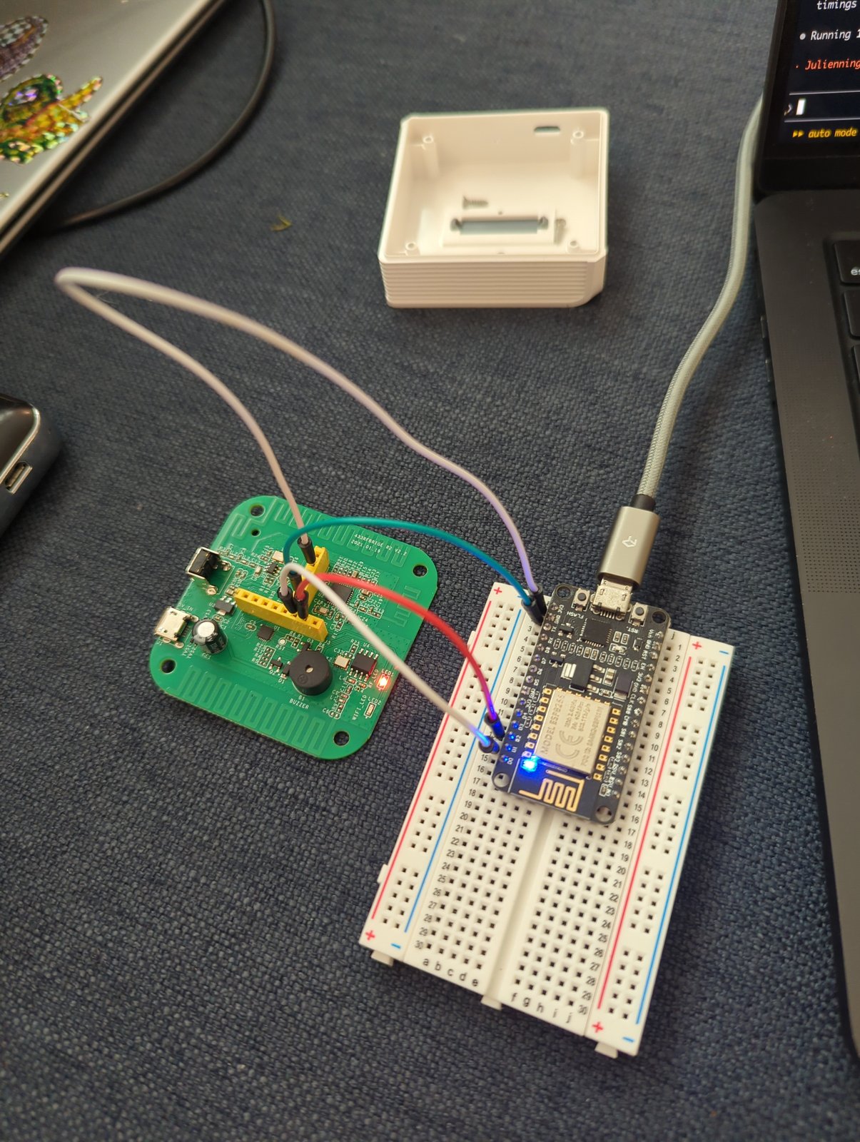 The RF bridge's circuit board, removed from its case and wired to an ESP8266 dev board on a breadboard for flashing the radio chip